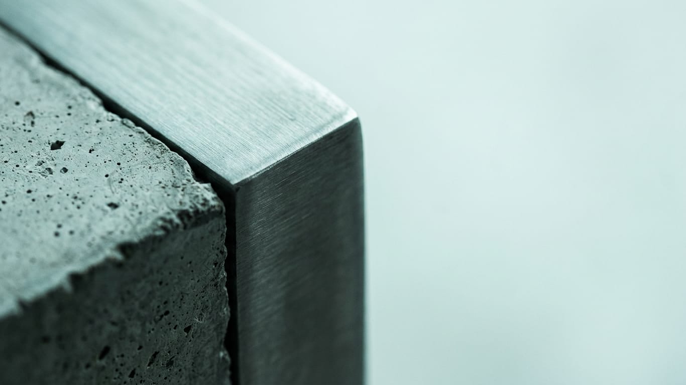 Illustration for this article: AI agent as a privileged identity, not software. Poured concrete meeting brushed steel at a tight seam, the joint slightly misaligned.