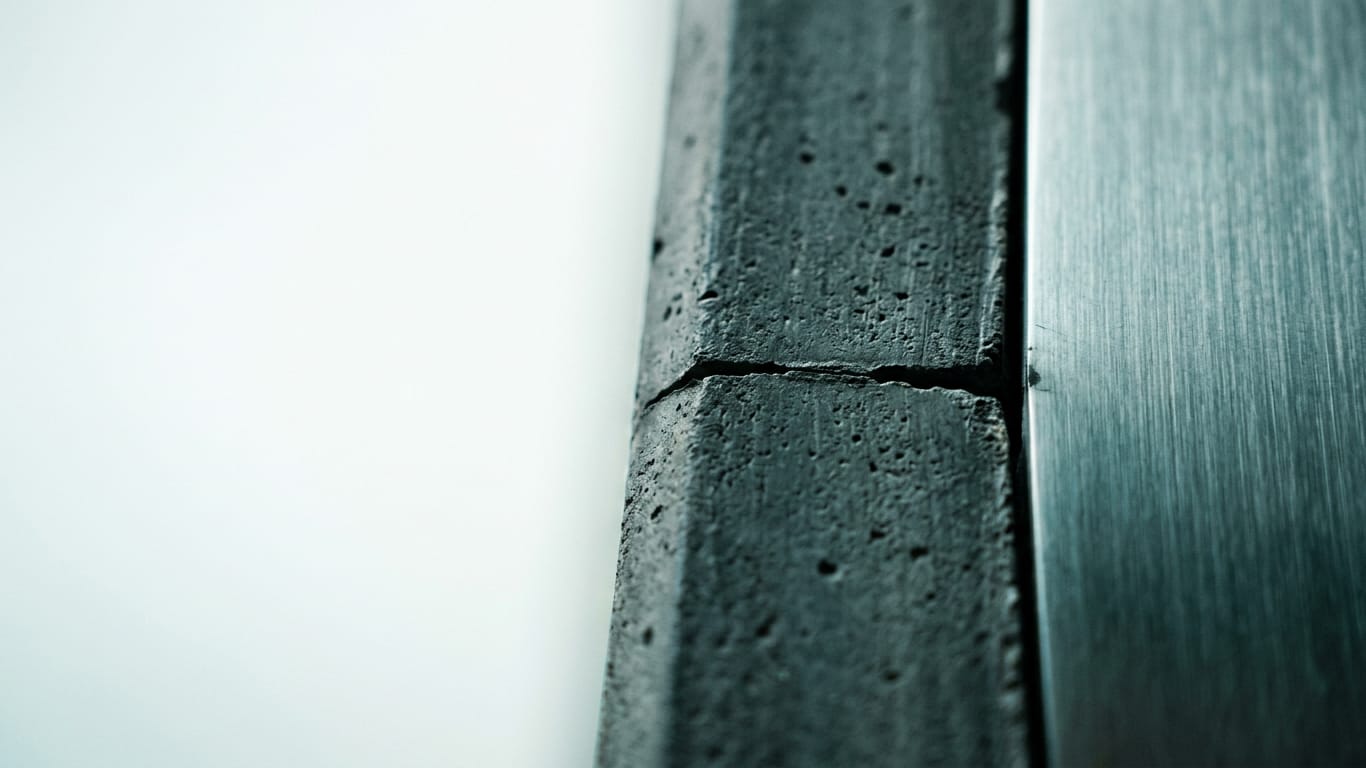 Illustration for this article: Article 25 AI Act makes audit rights in AI contracts a legal obligation. Poured concrete meeting brushed steel at a tight seam, the joint slightly misaligned.