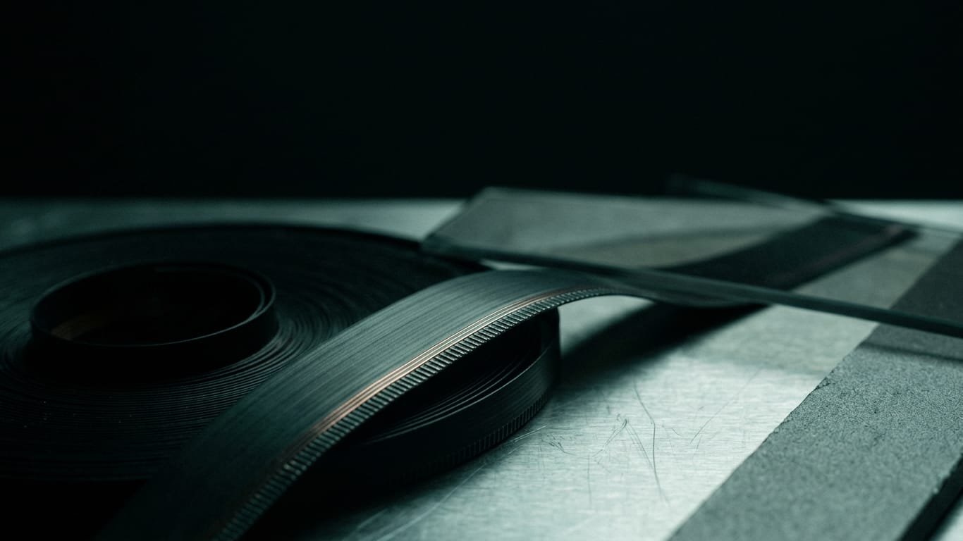 Illustration for this article: Confidence scores from AI models. A coil of unbranded ribbon cable unspooling across a matte floor into darkness.