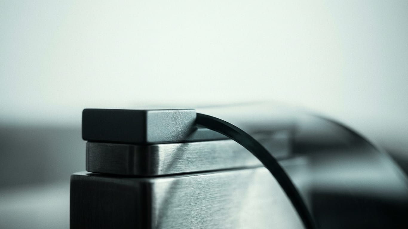Illustration for this article: Demonstrable control over AI use by lawyers. The cut edges of a thick stack of blank paper, fanned slightly, raking light along the fibres.