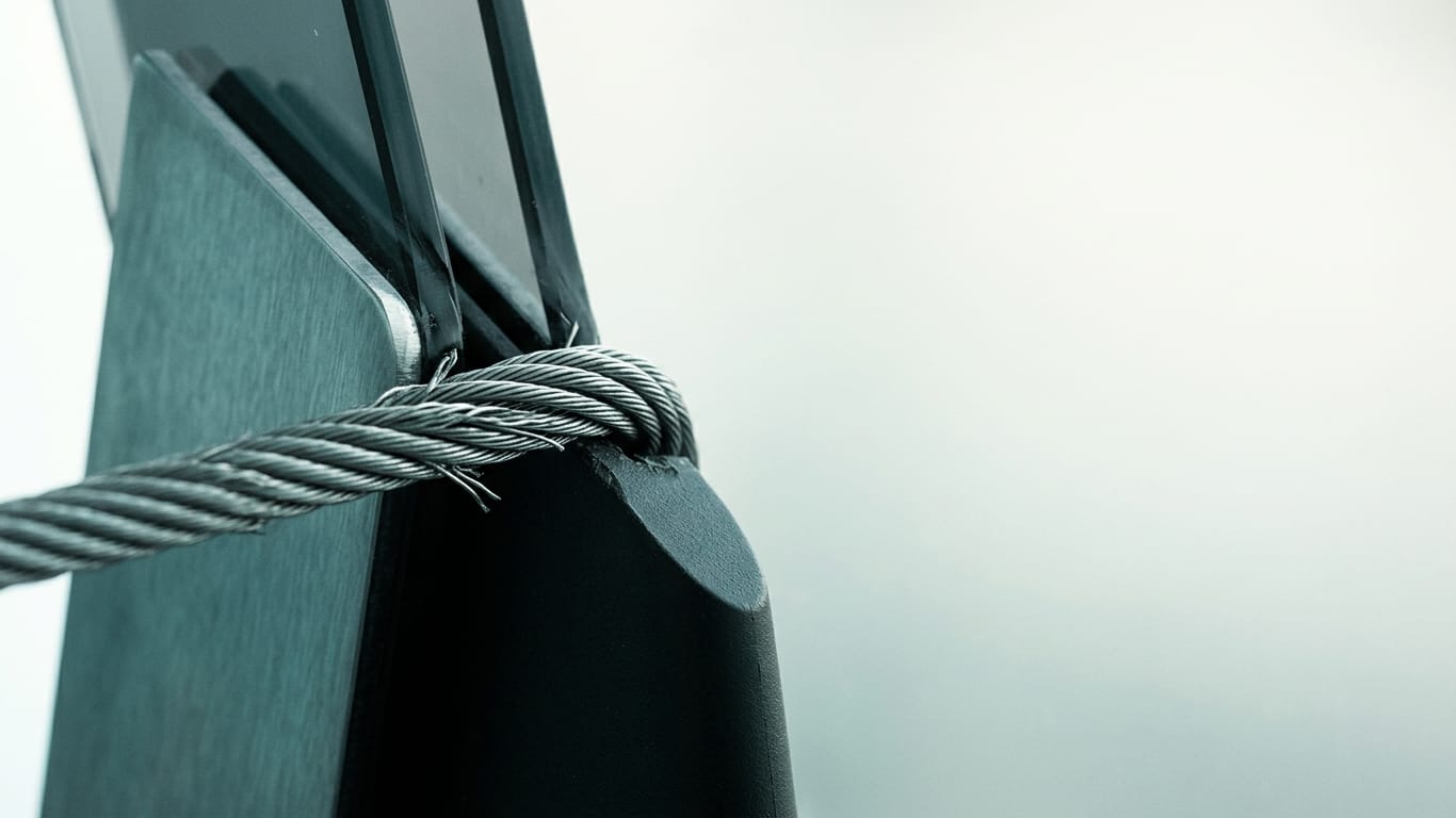 Illustration for this article: LawZero as a publicly funded AI alternative. A steel cable under visible tension, strands separating where it passes over an edge.