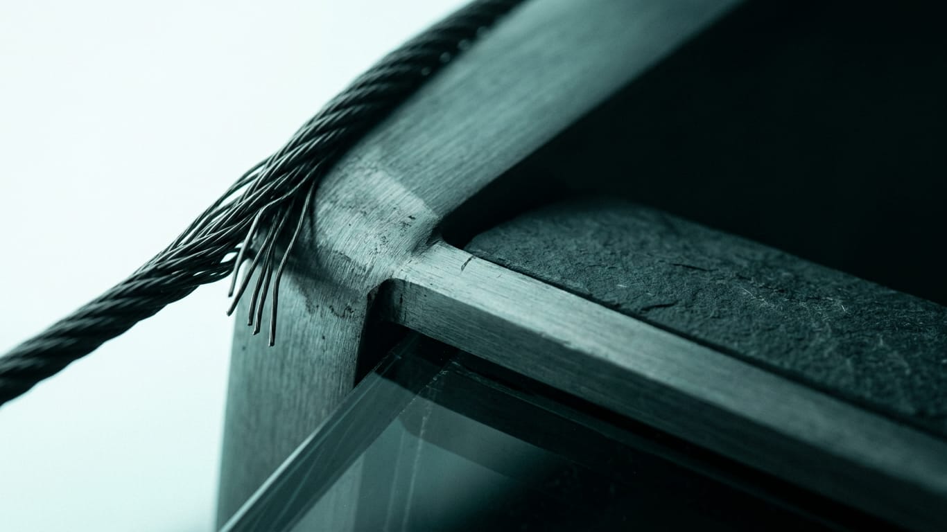 Illustration for this article: prEN 18229-1 structures AI logging and claim checking. A steel cable under visible tension, strands separating where it passes over an edge.