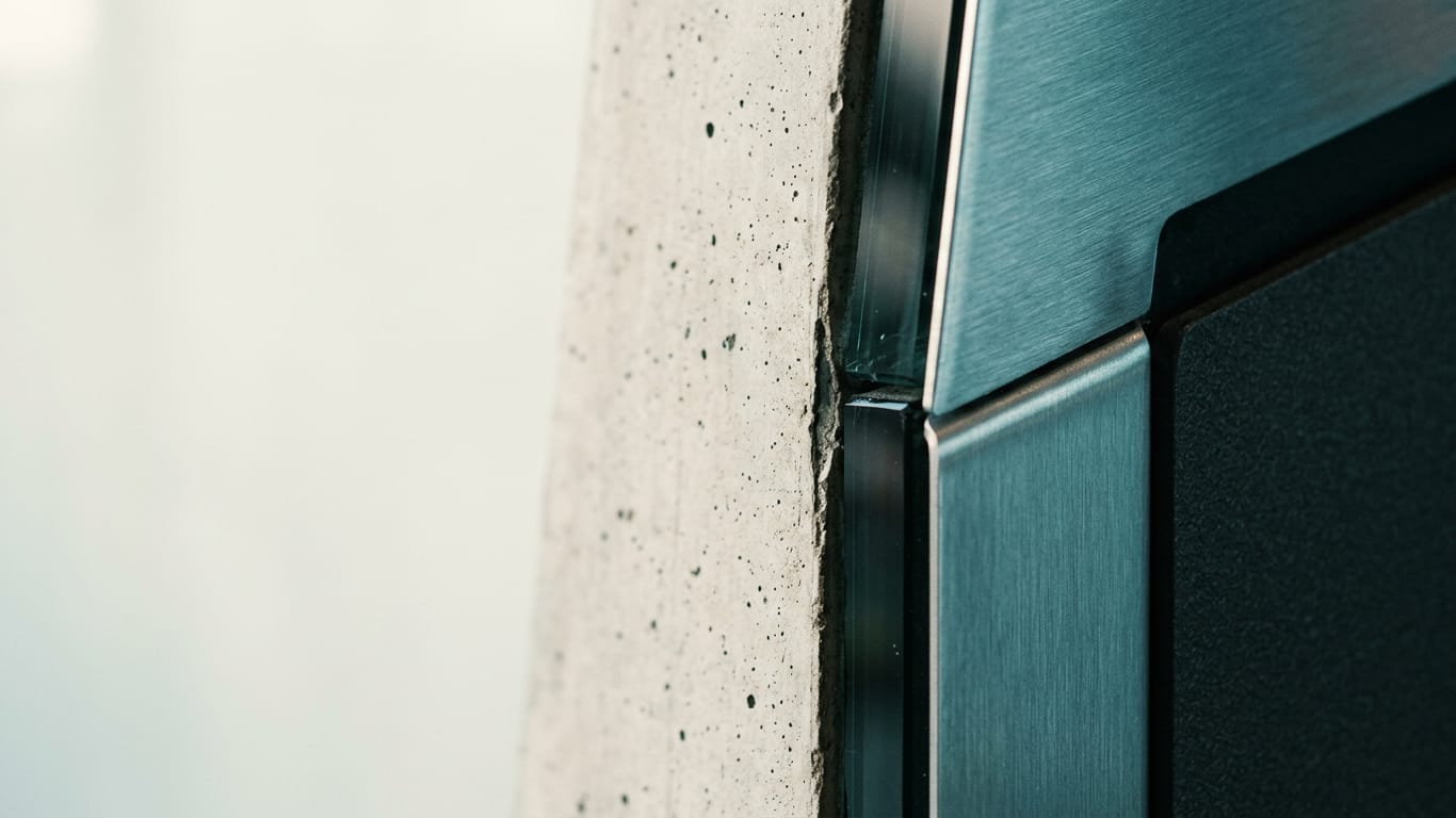 Illustration for this article: Privacy Gate DPG Media. Poured concrete meeting brushed steel at a tight seam, the joint slightly misaligned.