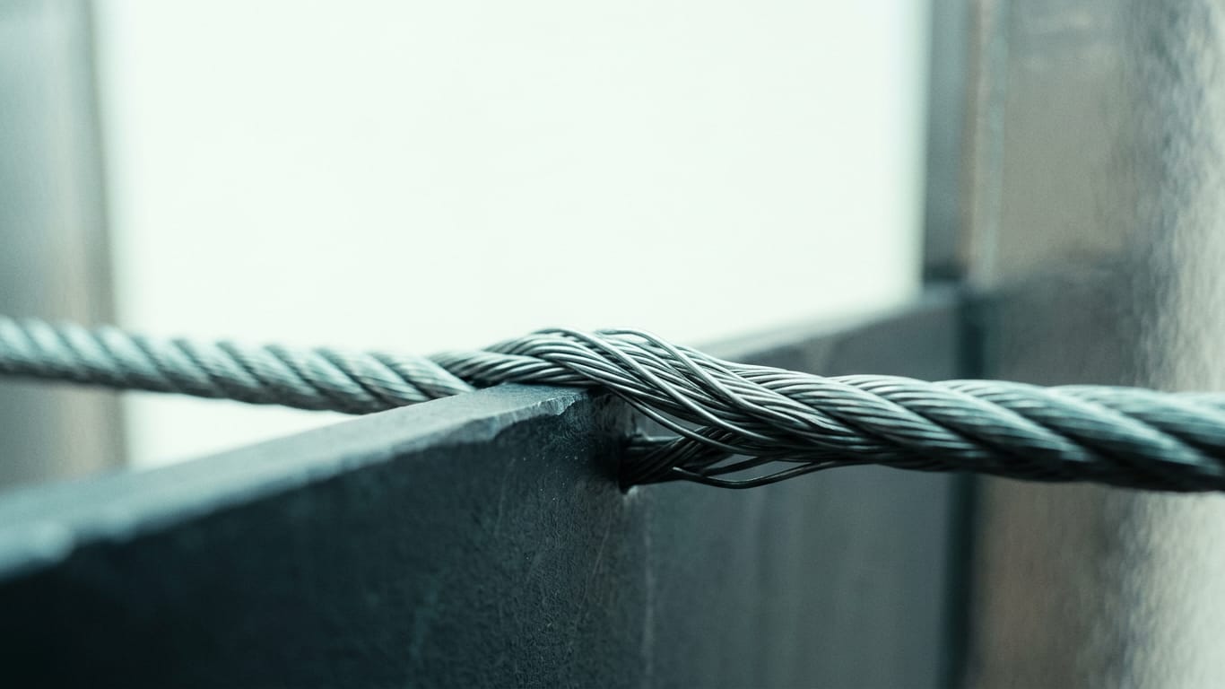 Illustration for this article: Safe AI use for lawyers and notaries requires a verification layer, not cautious prompts. A steel cable under visible tension, strands separating where it passes over an edge.