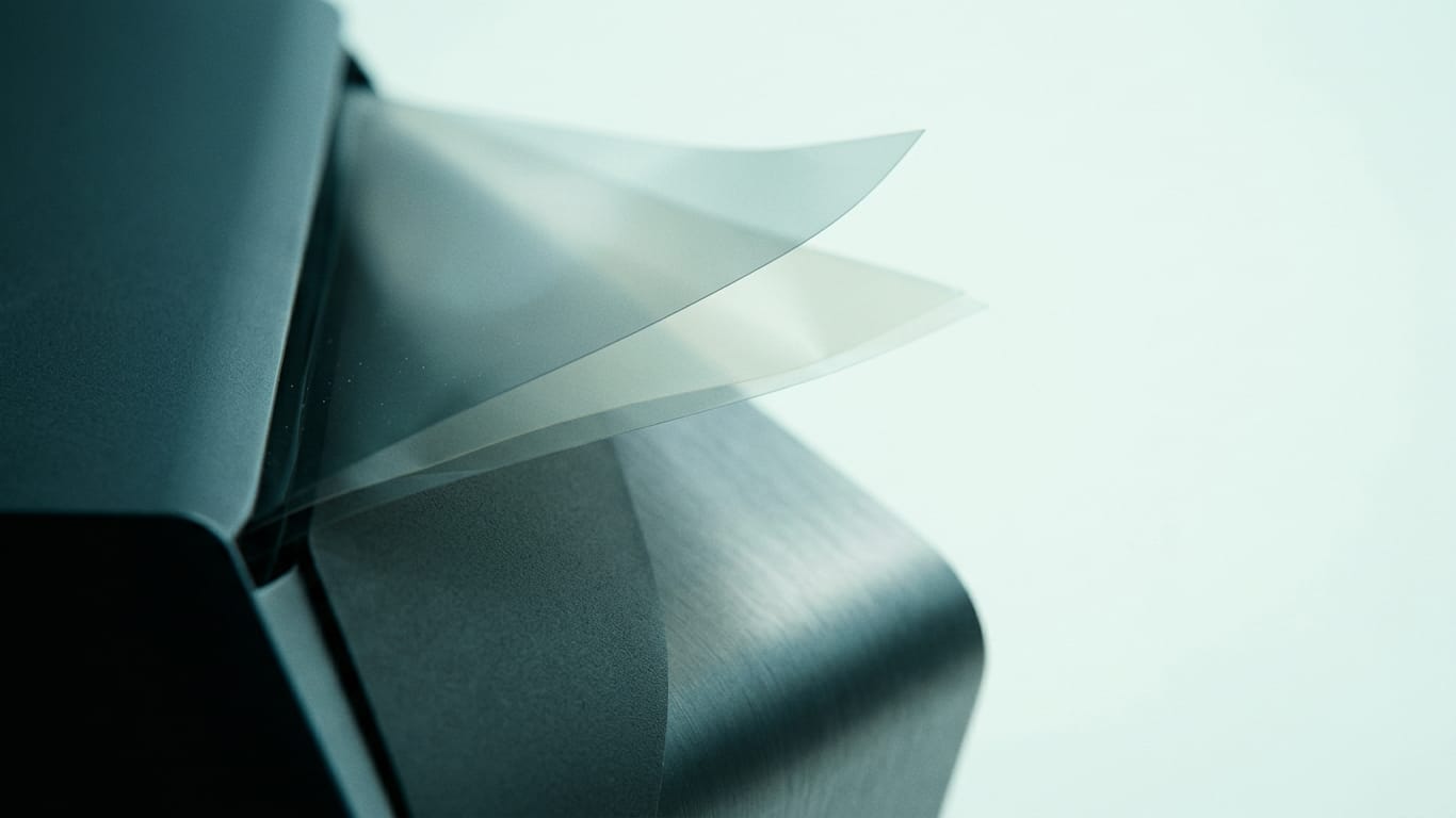 Illustration for this article: Senate shifts rogue-AI debate to liability for agent actions. Layers of translucent film lifted apart, light scattering between the sheets.