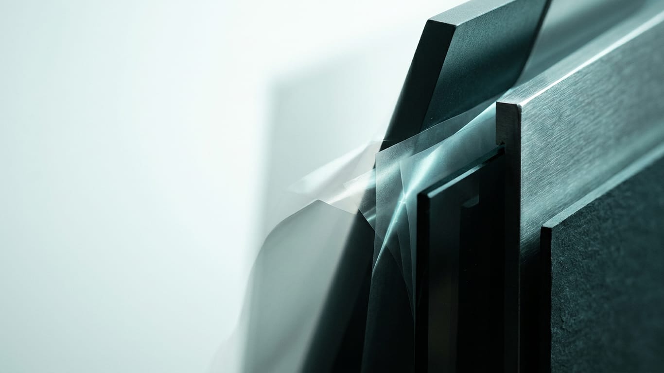 Illustration for this article: The hidden data layer in AI terms. Layers of translucent film lifted apart, light scattering between the sheets.
