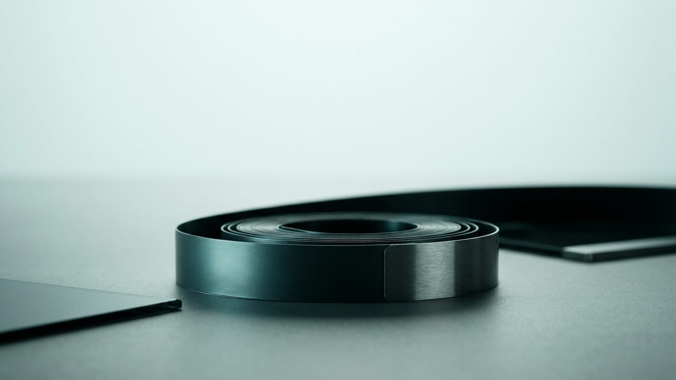 Illustration for this article: Threshold values for AI decisions are becoming a legal design variable. A coil of unbranded ribbon cable unspooling across a matte floor into darkness.