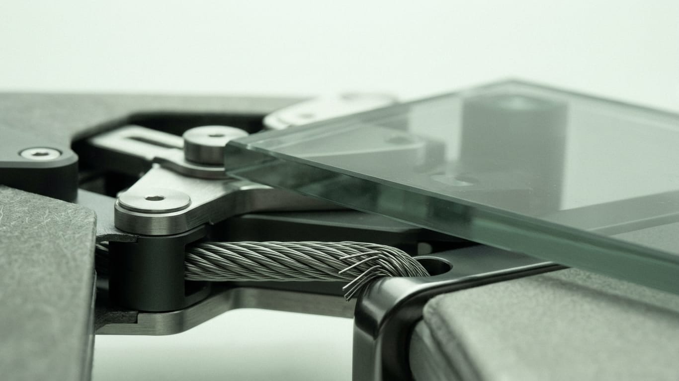 Illustration for this article: Verifying routing, trust anchors and robot control before you call an AI workflow reliable. A steel cable under visible tension, strands separating where it passes over an edge.